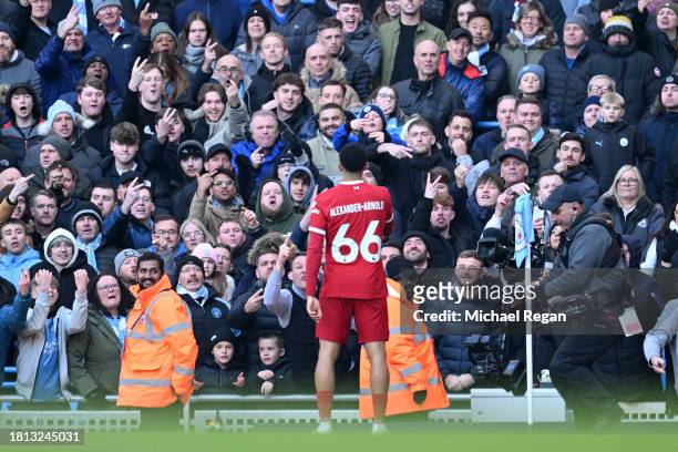 Manchester City fans react as Trent Alexander-Arnold of Liverpool celebrates after scoring the team's first goal during the Premier League match...
