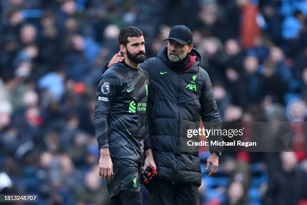 Dejected Alisson Becker of Liverpool is consoled by Manager Juergen Klopp after he sustains an injury during the draw in the Premier League match...