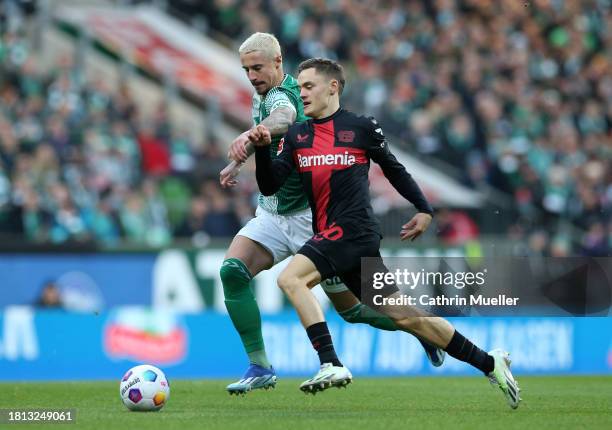 Marco Friedl of Werder Bremen and Florian Wirtz of Bayer Leverkusen battle for possession during the Bundesliga match between SV Werder Bremen and...