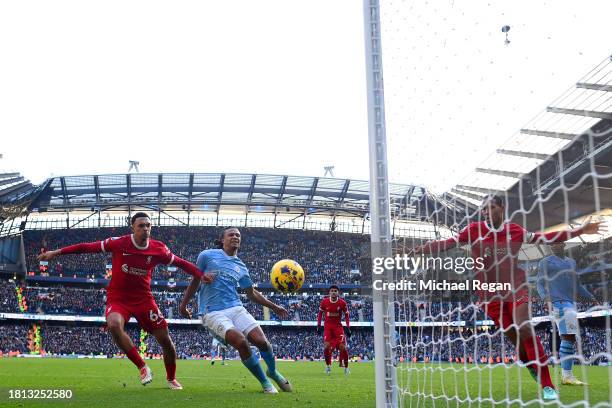 Nathan Ake of Manchester City shoots but misses whilst under pressure from Trent Alexander-Arnold of Liverpool during the Premier League match...