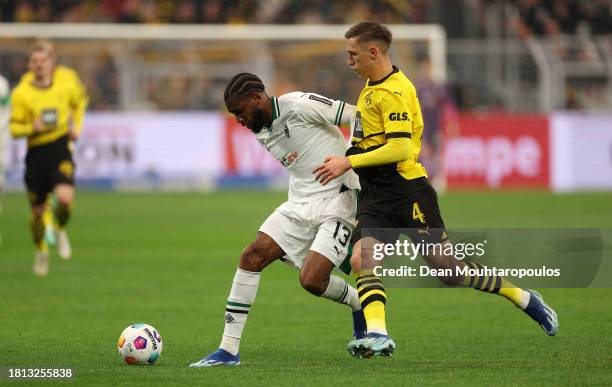 Jordan Siebatcheu of Borussia Moenchengladbach is challenged by Nico Schlotterbeck of Borussia Dortmund during the Bundesliga match between Borussia...
