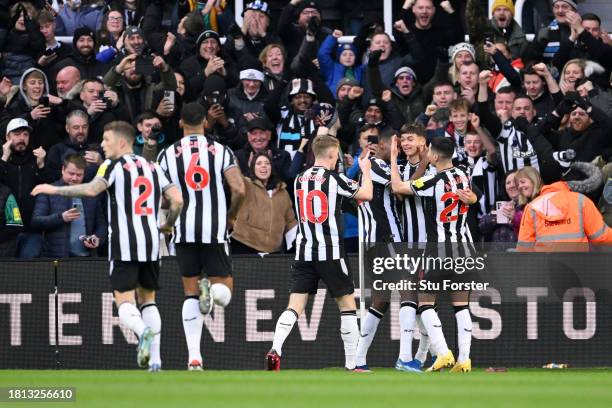 Alexander Isak of Newcastle United celebrates with teammates after scoring the team's first goal during the Premier League match between Newcastle...