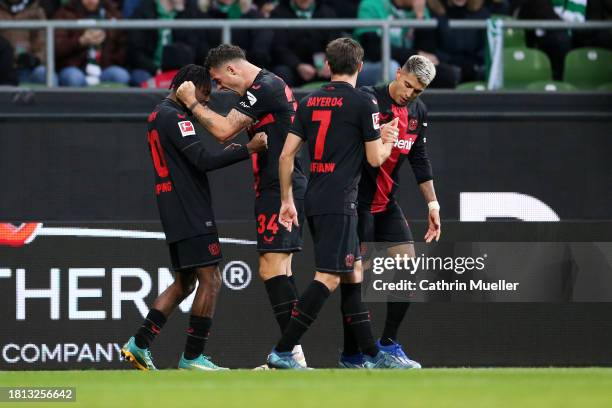 Jeremie Frimpong of Bayer Leverkusen celebrates with teammate Granit Xhaka after scoring the team's second goal during the Bundesliga match between...