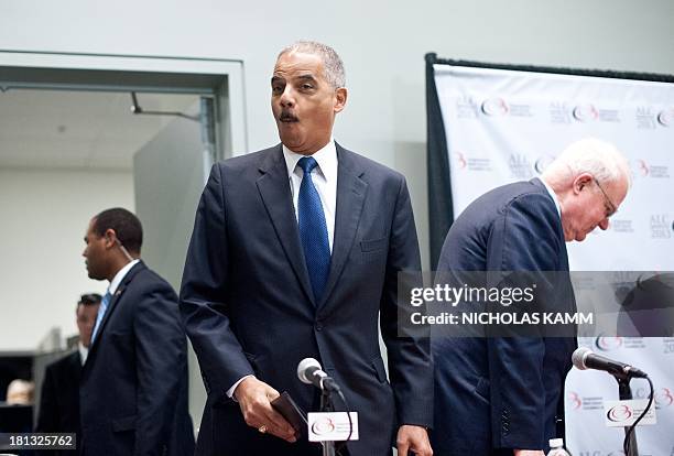 Attorney General Eric Holder reacts to host Representative Melvin Watt as he arrives to address the Congressional Black Caucus Annual Legislative...