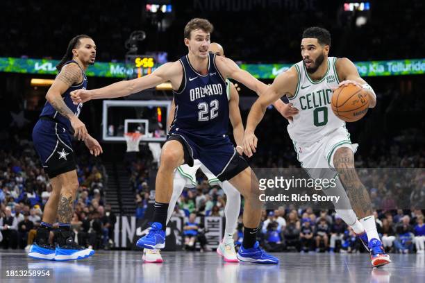 Jayson Tatum of the Boston Celtics dribbles the ball past Franz Wagner of the Orlando Magic during the first half at Amway Center on November 24,...