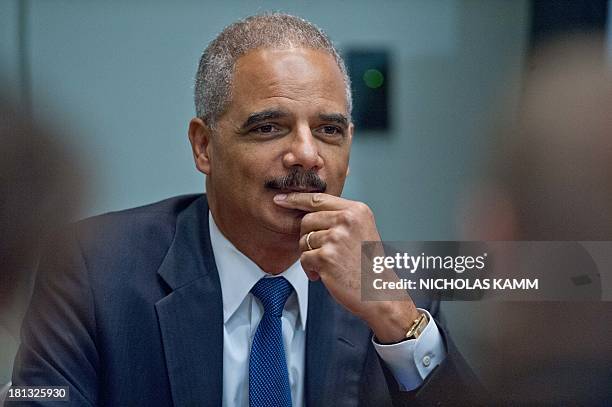 Attorney General Eric Holder listens to a speaker after addressing a public policy forum on voting rights at the Congressional Black Caucus Annual...