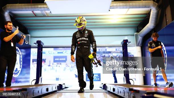 11th placed qualifier Lewis Hamilton of Great Britain and Mercedes walks in the FIA garage during qualifying ahead of the F1 Grand Prix of Abu Dhabi...