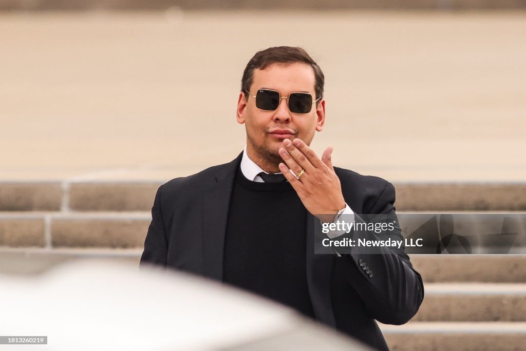 U.S. Rep. George Santos blows kiss as he leaves Long Island court