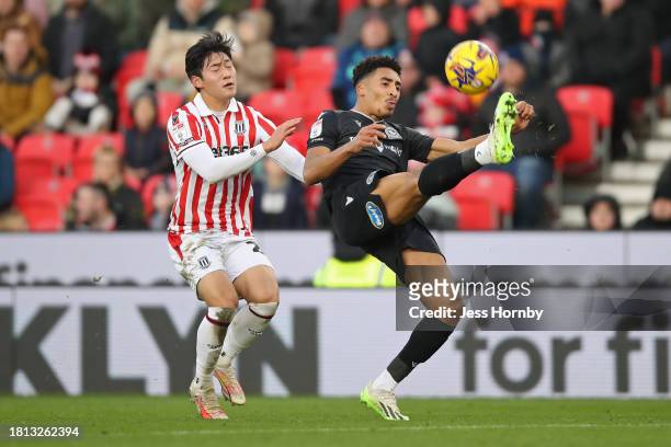 James Hill of Blackburn Rovers is put under pressure by Bae Jun-Ho of Stoke City during the Sky Bet Championship match between Stoke City and...