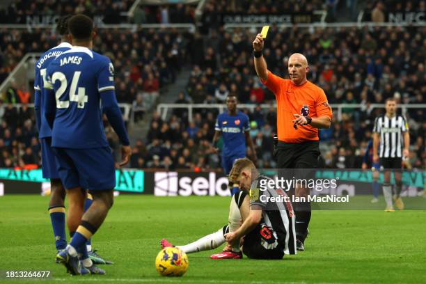 Referee, Simon Hooper shows a yellow card to Lesley Ugochukwu of Chelsea during the Premier League match between Newcastle United and Chelsea FC at...