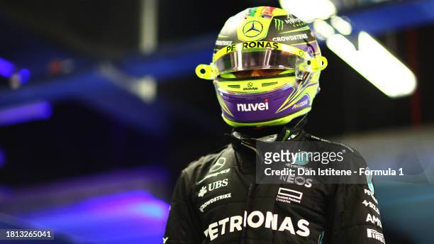 11th placed qualifier Lewis Hamilton of Great Britain and Mercedes looks on in the FIA garage during qualifying ahead of the F1 Grand Prix of Abu...