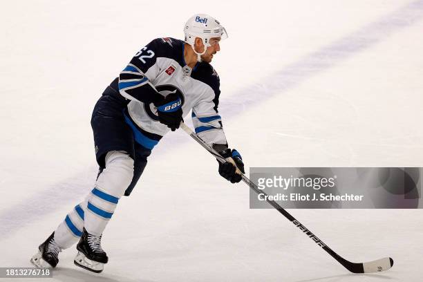 Nino Niederreiter of the Winnipeg Jets skates with the puck against the Florida Panthers at the Amerant Bank Arena on November 24, 2023 in Sunrise,...