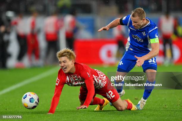 Fabian Holland of SV Darmstadt 98 clashes with Ritsu Doan of Sport-Club Freiburg during the Bundesliga match between Sport-Club Freiburg and SV...