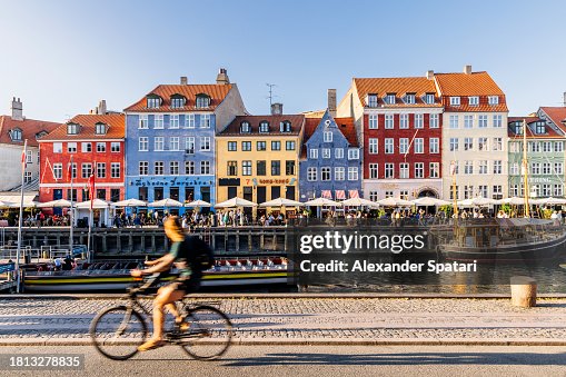 Nyhavn harbour with restaurants and crowds of tourists on a sunny summer day, Copenhagen, Denmark Nyhavn harbour with restaurants and crowds of tourists on a sunny summer day, Copenhagen, Denmark