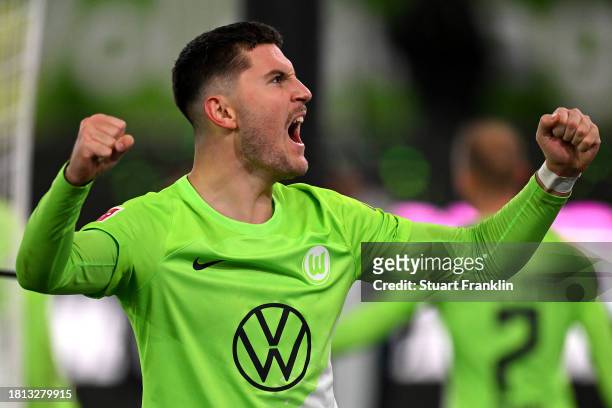 Jonas Wind of VfL Wolfsburg celebrates after teammate Rogerio scores his team's second goal during the Bundesliga match between VfL Wolfsburg and RB...