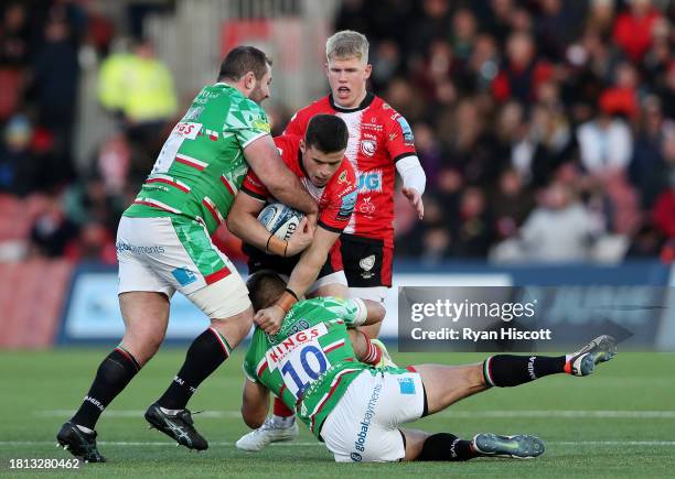 Seb Atkinson of Gloucester Rugby is tackled by James Cronin and Handre Pollard of Leicester Tigers during the Gallagher Premiership Rugby match...