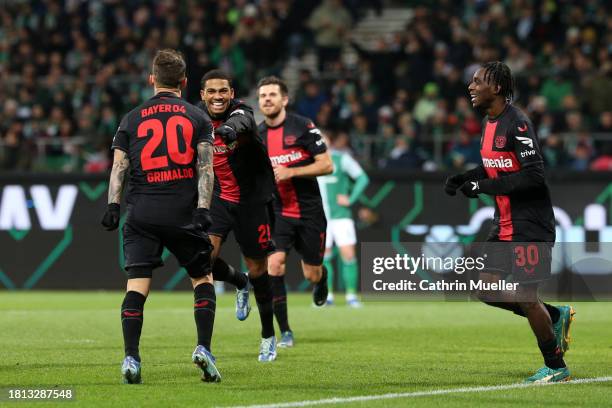 Alex Grimaldo of Bayer Leverkusen celebrates with teammates after scoring the team's third goal during the Bundesliga match between SV Werder Bremen...