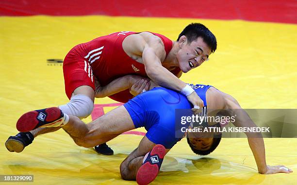 People Republic Korea's Won Chol Yun and South Korea's Gyujin Choi fight for the gold at the men's Greco-Roman style 55 kg category final of the FILA...