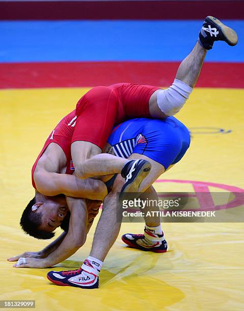 People Republic Korea's Won Chol Yun and South Korea's Gyujin Choi fight for the gold at the men's Greco-Roman style 55 kg category final of the FILA...