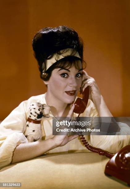 Connie Francis talks on the phone in publicity portrait for the film 'Follow The Boys', 1963.