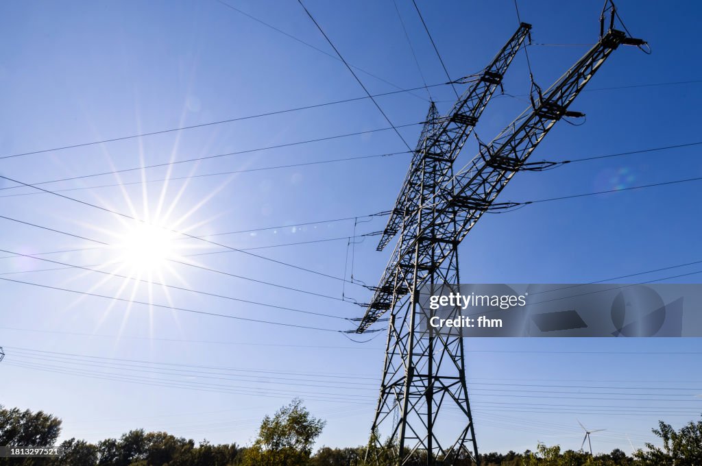Electricity pylons with bright sun