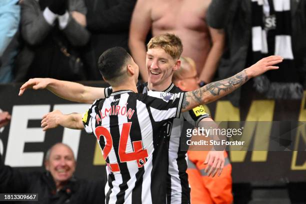 Anthony Gordon of Newcastle United celebrates with teammate Miguel Almiron after scoring the team's fourth goal during the Premier League match...