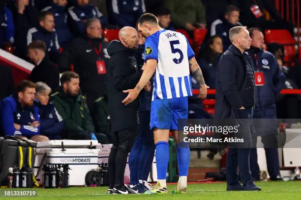 Lewis Dunk of Brighton & Hove Albion talks to Fourth Official, Andy Davies after being shown a red card during the Premier League match between...