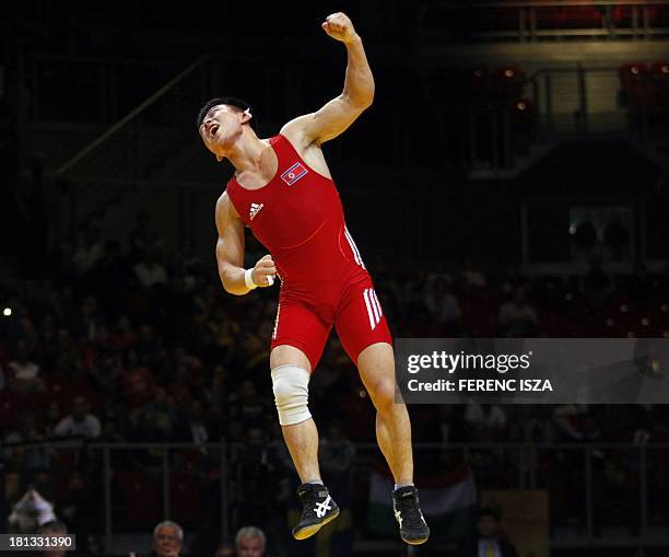 People Republic of Korea's Won Chol Yun celebrates his win againts Korea's Gyujin Choi during the final round of the men's Greco-Roman 55 kg category...