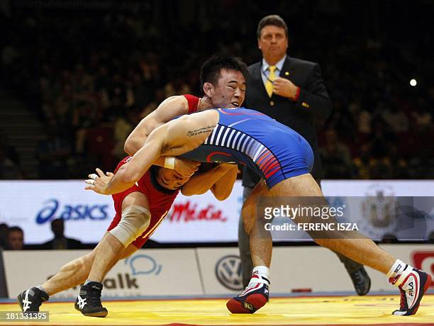 People Republic of Korea's Won Chol Yun fights with Korea's Gyujin Choi during the final round of the men's Greco-Roman 55 kg category of the World...