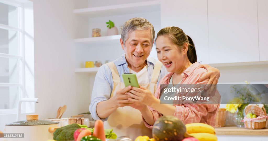 Asian elderly couple in kitchen