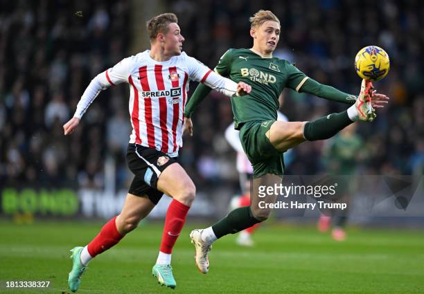 Ben Waine of Plymouth Argyle battles for possession with Daniel Ballard of Sunderland during the Sky Bet Championship match between Plymouth Argyle...