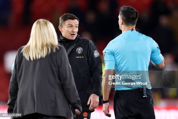 Paul Heckingbottom, Manager of Sheffield United, interacts with Referee Andrew Madley at full-time after the team's defeat in the Premier League...