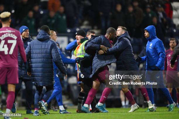 Yakou Meite of Cardiff City tussle at the end of the Sky Bet Championship match between Preston North End and Cardiff City at Deepdale on November...