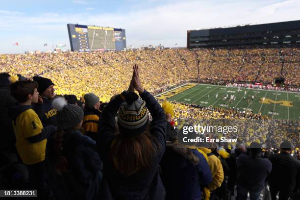 Fans watch during the first quarter in the game between the Ohio State Buckeyes and the Michigan Wolverines at Michigan Stadium on November 25, 2023...