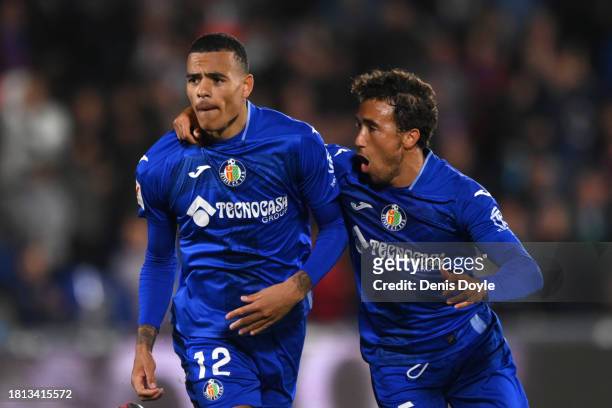 Mason Greenwood of Getafe CF celebrates with teammate Luis Milla after scoring the team's first goal during the LaLiga EA Sports match between Getafe...