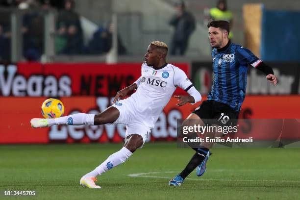 Victor Osimhen of SSC Napoli passes the ball whilst under pressure from Berat Djimsiti of Atalanta BC during the Serie A TIM match between Atalanta...