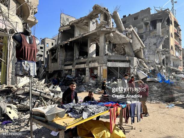 Palestinians, live in Nuseirat refugee camp, are seen shopping at a local bazaar during the humanitarian pause in Deir al-Balah, Gaza on November 30,...