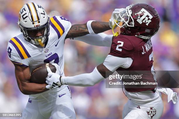 Malik Nabers of the LSU Tigers runs with the ball as Jacoby Mathews of the Texas A&M Aggies defends during the first half at Tiger Stadium on...