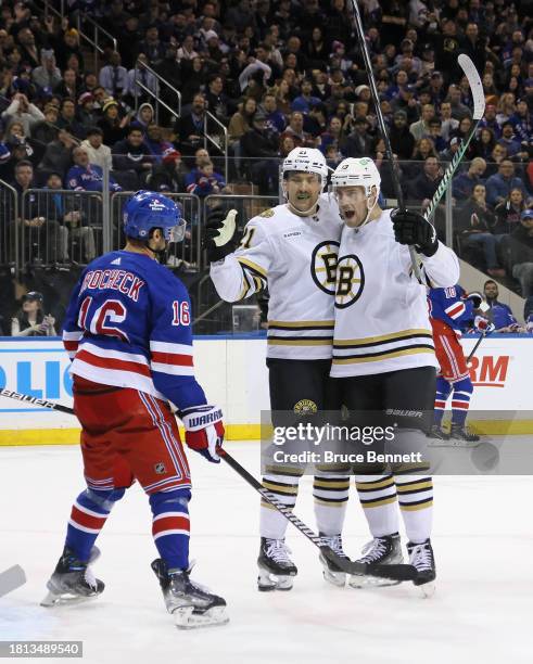 Charlie Coyle of the Boston Bruins celebrates his first period goal against the New York Rangers along with James van Riemsdyk at Madison Square...