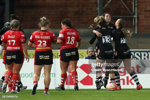 Tess Feury of Leicester Tigers celebrates with teammates after scoring their sides first try during the Allianz Premiership Women's Rugby match...