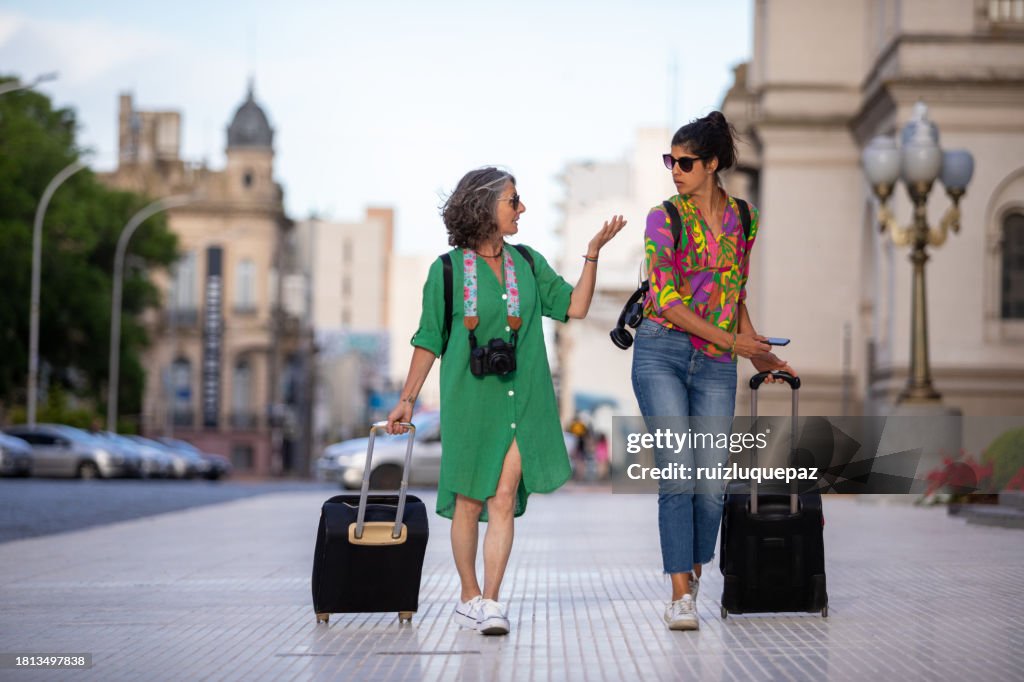 Two female tourists walking through the city