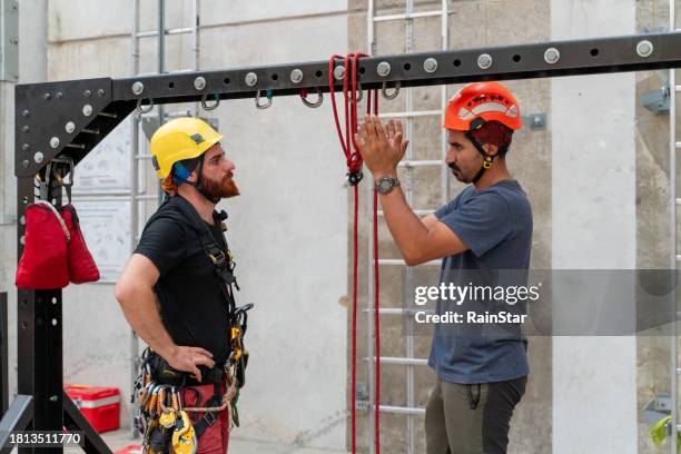 young engineers make their plans before the climb - careerbuilder challenge stock pictures, royalty-free photos & images