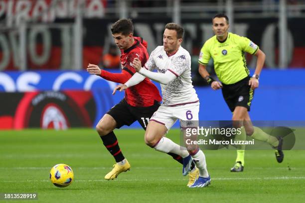 Christian Pulisic of AC Milan battles for possession with Arthur of ACF Fiorentina during the Serie A TIM match between AC Milan and ACF Fiorentina...
