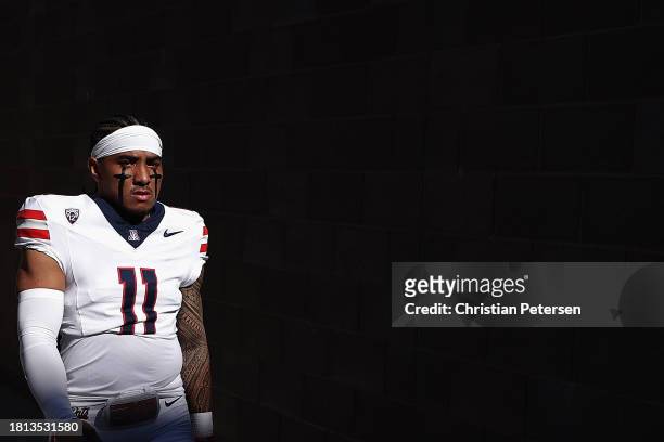 Quarterback Noah Fifita of the Arizona Wildcats walks out to the field before the NCAAF game against the Arizona State Sun Devils at Mountain America...