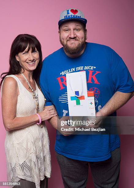 Actor Stephen Kramer Glickman gets a gift from Sherrie Berry of 'Skin Again' at the Mark Kearney Group "Iced Out" Luxury Emmy Suite on September 19,...