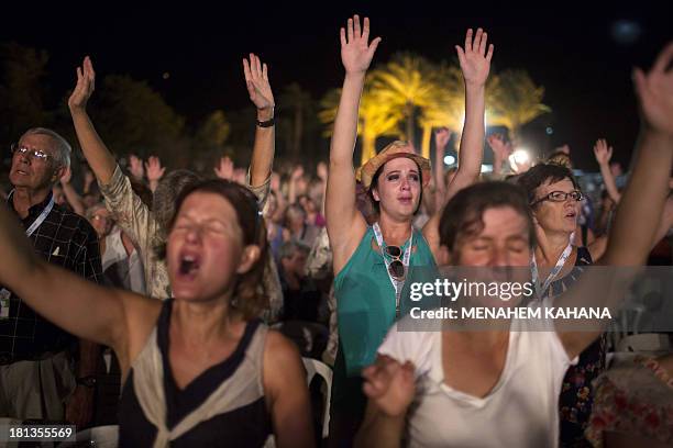 Thousands of evangelical Christian pilgrims pray during a prayer gathering on the Dead Sea shore in Ein Gedi on September 20, 2013 in the Judean...