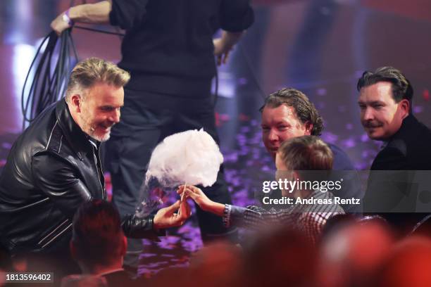 Gary Barlow serves cotton candy to the audience during the "Wetten, Dass ...?" tv show on November 25, 2023 in Offenburg, Germany.