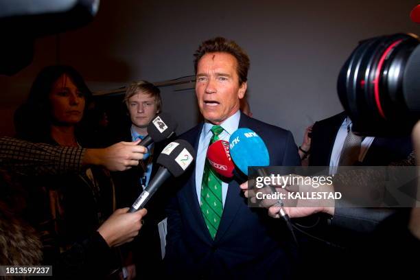 Austria-born actor and former governor of California Arnold Schwarzenegger speaks to journalists after delivering a speech during the Zero Emission...