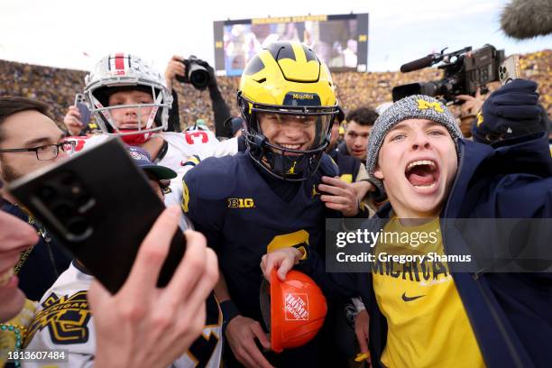 McCarthy of the Michigan Wolverines celebrates with fans on the field after defeating the Ohio State Buckeyes in the game at Michigan Stadium on...