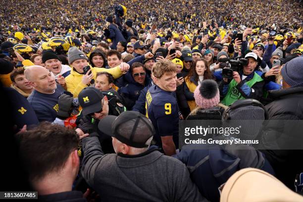McCarthy of the Michigan Wolverines celebrates with fans on the field after defeating the Ohio State Buckeyes in the game at Michigan Stadium on...